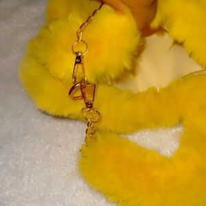 Beautiful Sassy, yellow heart shaped fur purse with a zipper and fur balls